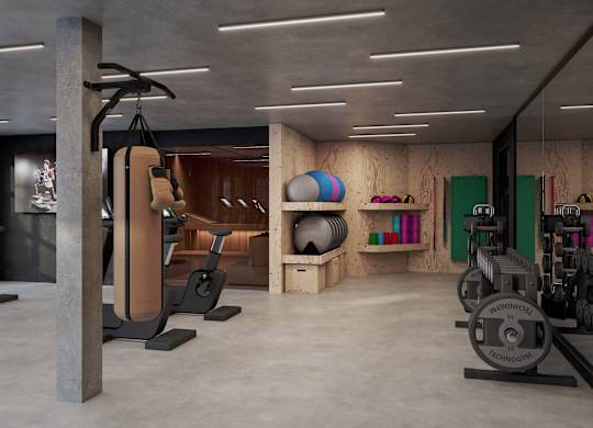 A gym with a variety of equipment including weights and a treadmill.