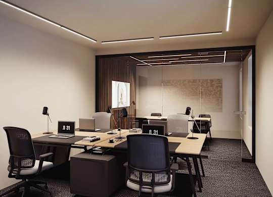 A modern office space with desks, chairs, and computers.