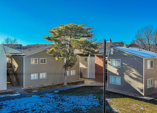 A row of houses with a blue tarp covering the ground.