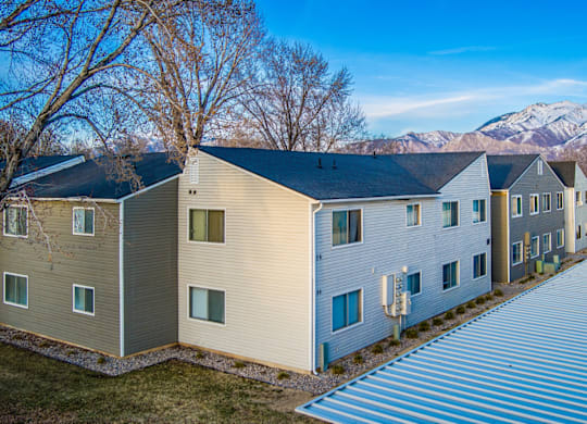 A row of houses with a mountain in the background.