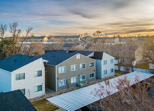 A row of houses with a grey roof.