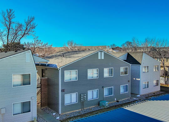A row of houses with a blue sky above them.