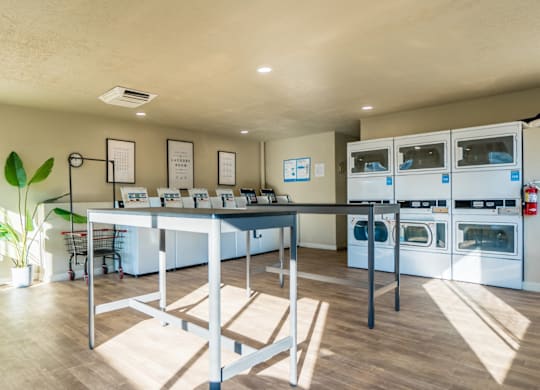 A kitchen with a table and chairs in the middle of the room.