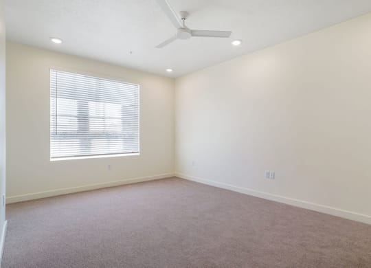 an empty bedroom with a large window