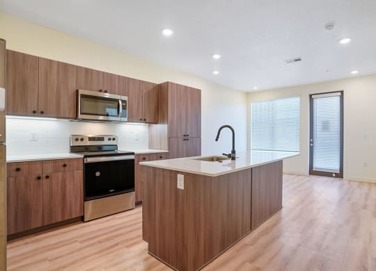 an empty kitchen with hardwood floors