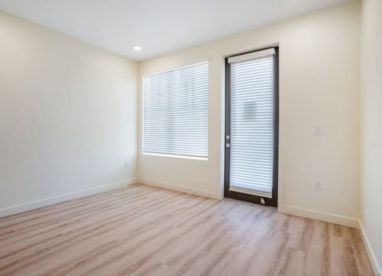 an empty living room with hardwood floors
