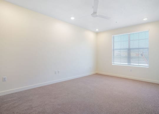 an empty bedroom with a window