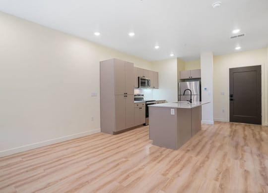 an empty kitchen with hardwood floors
