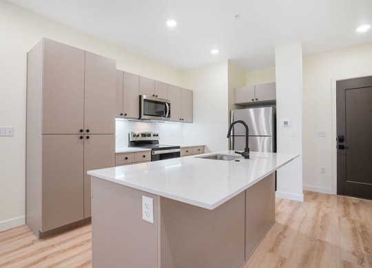 an empty kitchen with hardwood floors