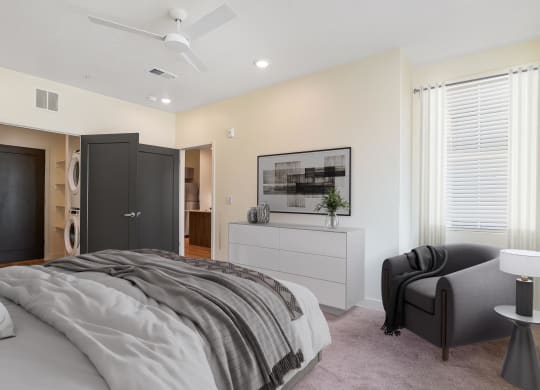 a bedroom with grey bedding