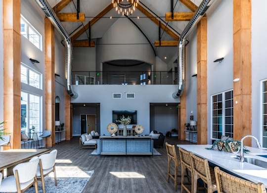 A large open space with a kitchen area and a dining table.