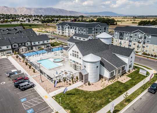 A large building with a pool in front of it.