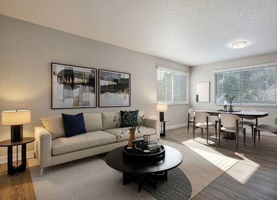A living room with a couch, coffee table, and pictures on the wall.
