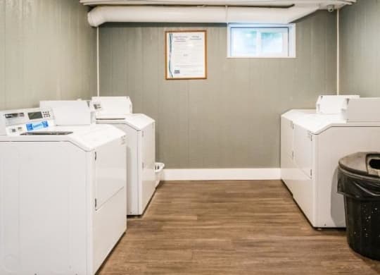 a row of white washing machines in a room