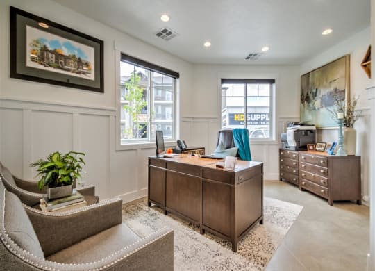 a home office with a desk and a chair at Aderra apartment complex in Roy, Utah