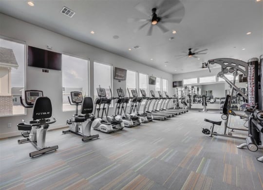 the gym is equipped with a row of exercise bikes  at Affinity 56 Apartments in West Jordan, Utah