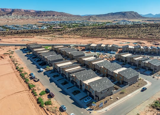 A large building complex with a parking lot in front of it.