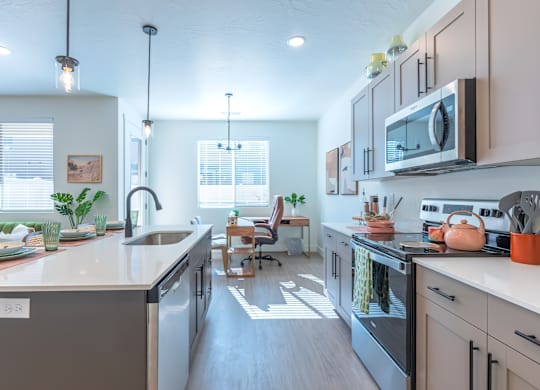 A modern kitchen with a large island and stainless steel appliances.