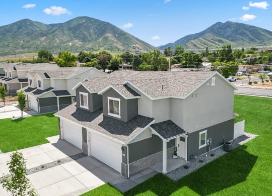 a group of houses with mountains in the background