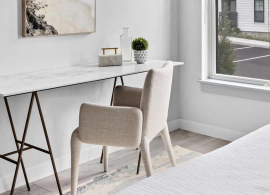 a bedroom with a bed and a desk with a chair
