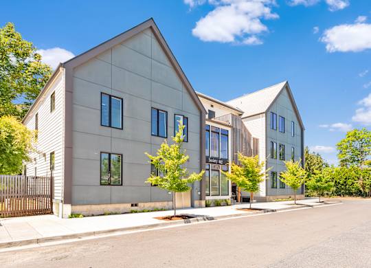 A modern house with a grey exterior and a black gate at Society 62 Apartments, Portland, Oregon