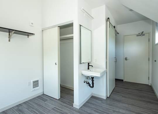 A bathroom with a sink and mirror at Society 62 Apartments, Portland, OR