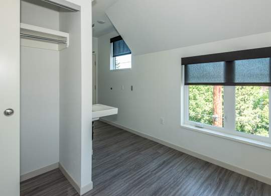 A room with a window and a bench. at Society 62 Apartments, Portland, OR, 97213