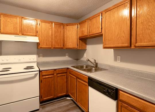 a kitchen with white appliances and wooden cabinets at Avon Crossings, North Carolina, 27713