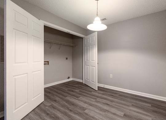 an empty bedroom with a closet and a door to the bathroom at Avon Crossings, North Carolina