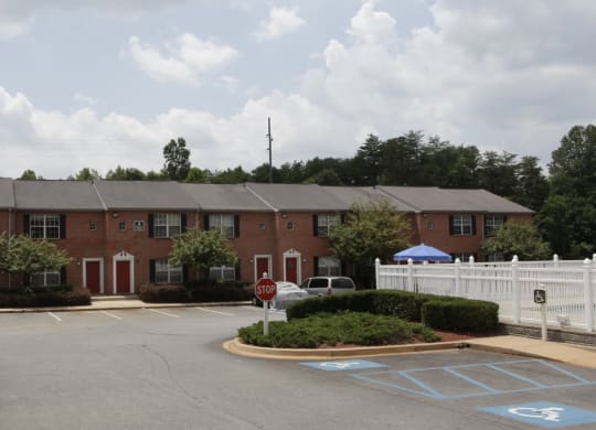 an apartment building with a parking lot in front of it at Brookside Pointe, Travelers Rest