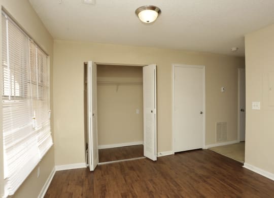 an empty living room with a large window and a closet at Brookside Pointe, Travelers Rest, SC 29690