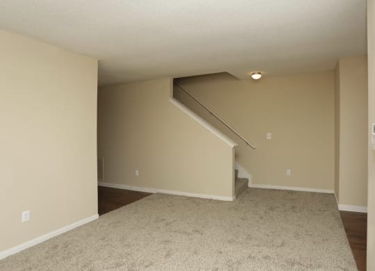 an empty living room with stairs and a carpeted floor at Brookside Pointe, Travelers Rest South Carolina