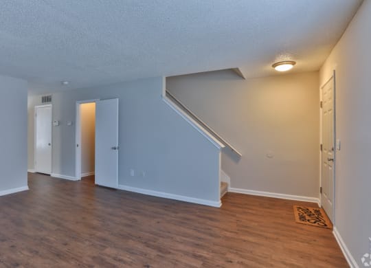 a living room with a hard wood floor and blue walls at Canaan Pointe, Greenville