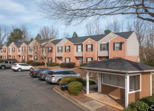 a row of apartment buildings with cars parked in a parking lot at Canaan Pointe, Greenville, South Carolina