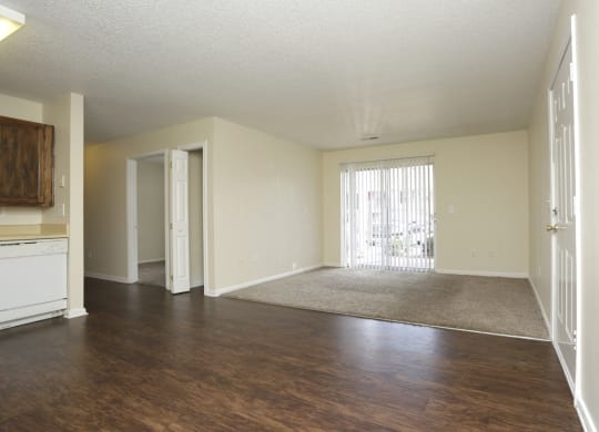 an empty living room with wood flooring and a door to a balcony at Canaan Pointe, Greenville South Carolina