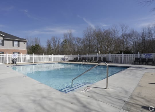 a resort style pool with a white fence and a house at Canaan Pointe, Greenville, 29607