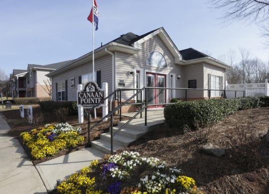 the front of a cream colored house with a flag and a sidewalk at Canaan Pointe, Greenville South Carolina