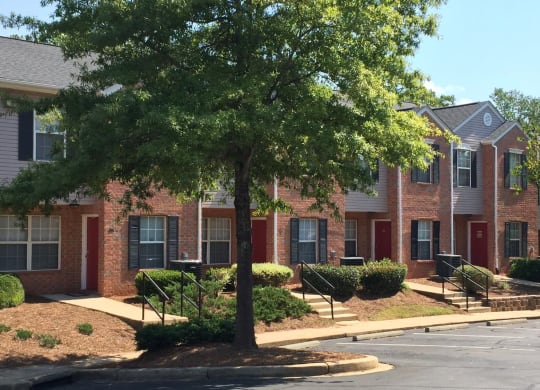 a tree in front of a brick apartment building at Canaan Pointe, Greenville South Carolina
