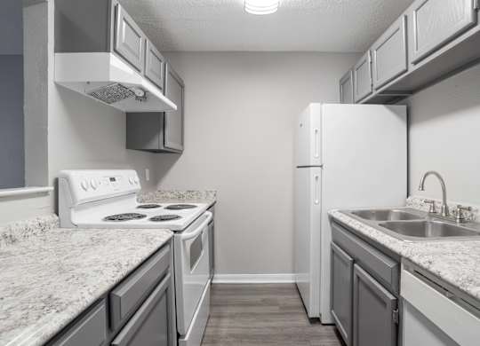 A kitchen with a white stove and a white refrigerator.at Jamestown Pointe Apartments, Greenville, SC
