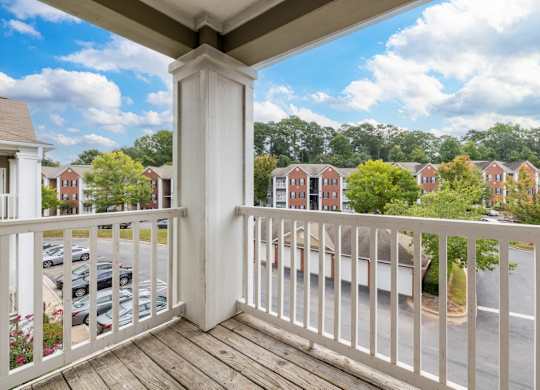 the view from the balcony of a home with a balcony railing at Magnolia Lake Apartments, Carrollton, GA