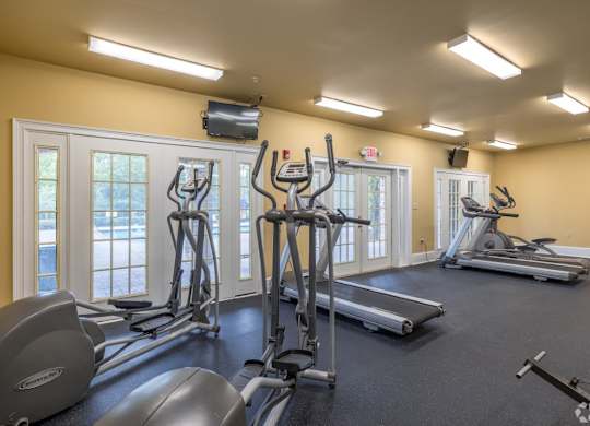 a gym with cardio equipment and windows at Magnolia Lake Apartments, Carrollton, 30117