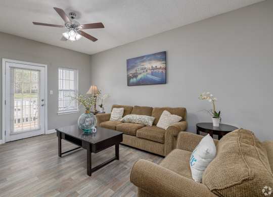 a living room with a couch and a table at Magnolia Lake Apartments, Carrollton, 30117