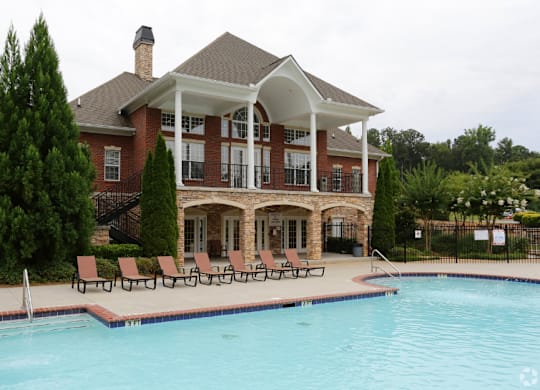 a large swimming pool in front of a house at Magnolia Lake Apartments, Carrollton, GA, 30117