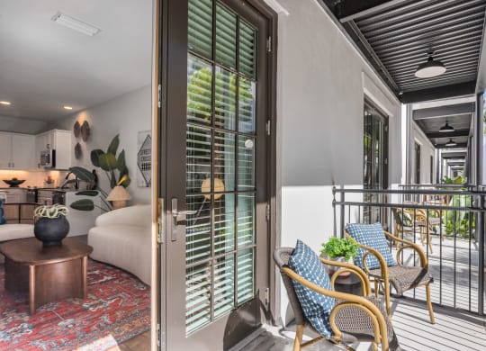 a living room with a bed and a balcony at Casa Marti, Tampa, FL