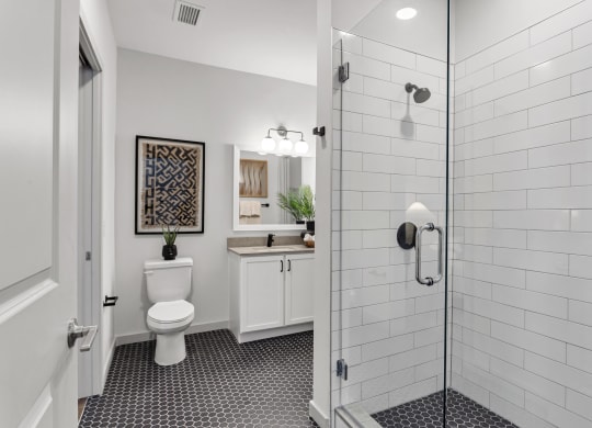 a white bathroom with a shower and a toilet at Casa Marti, Tampa, FL