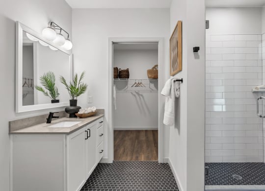a white bathroom with a shower and a sink and a mirror at Casa Marti, Tampa