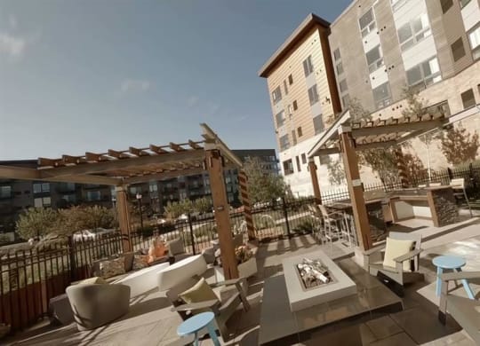 a patio with tables and chairs outside of a building at Bluestone Lofts, Duluth, 55803