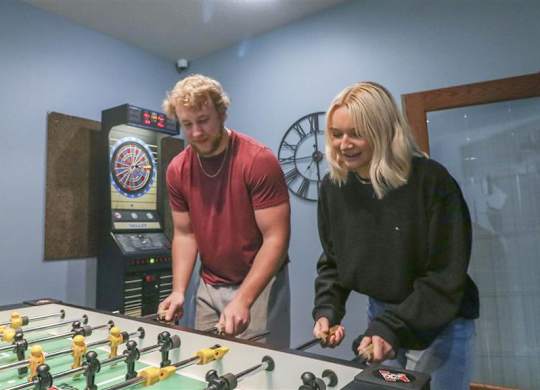 a man and a woman standing next to a foosball table at Boulder Ridge, Duluth, MN
