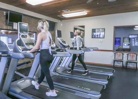 a woman walking on a treadmill in a gym at Boulder Ridge, Duluth Minnesota