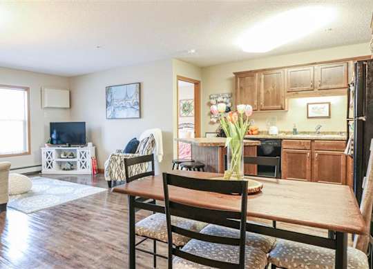 a living room and kitchen with a wooden table at Boulder Ridge, Duluth, MN 55811